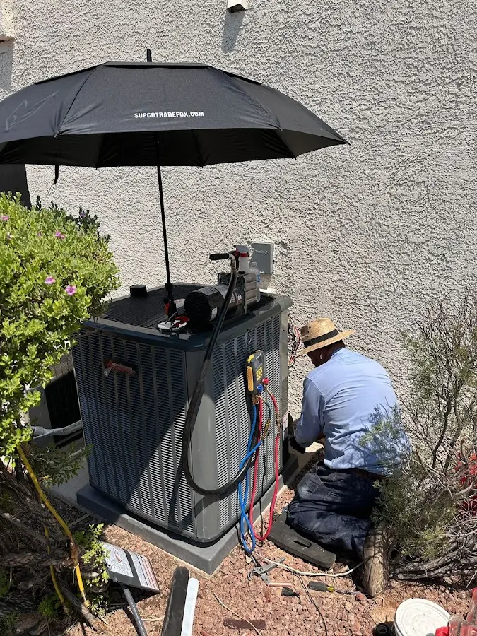 HVAC technician performing outdoor AC maintenance in Philomath